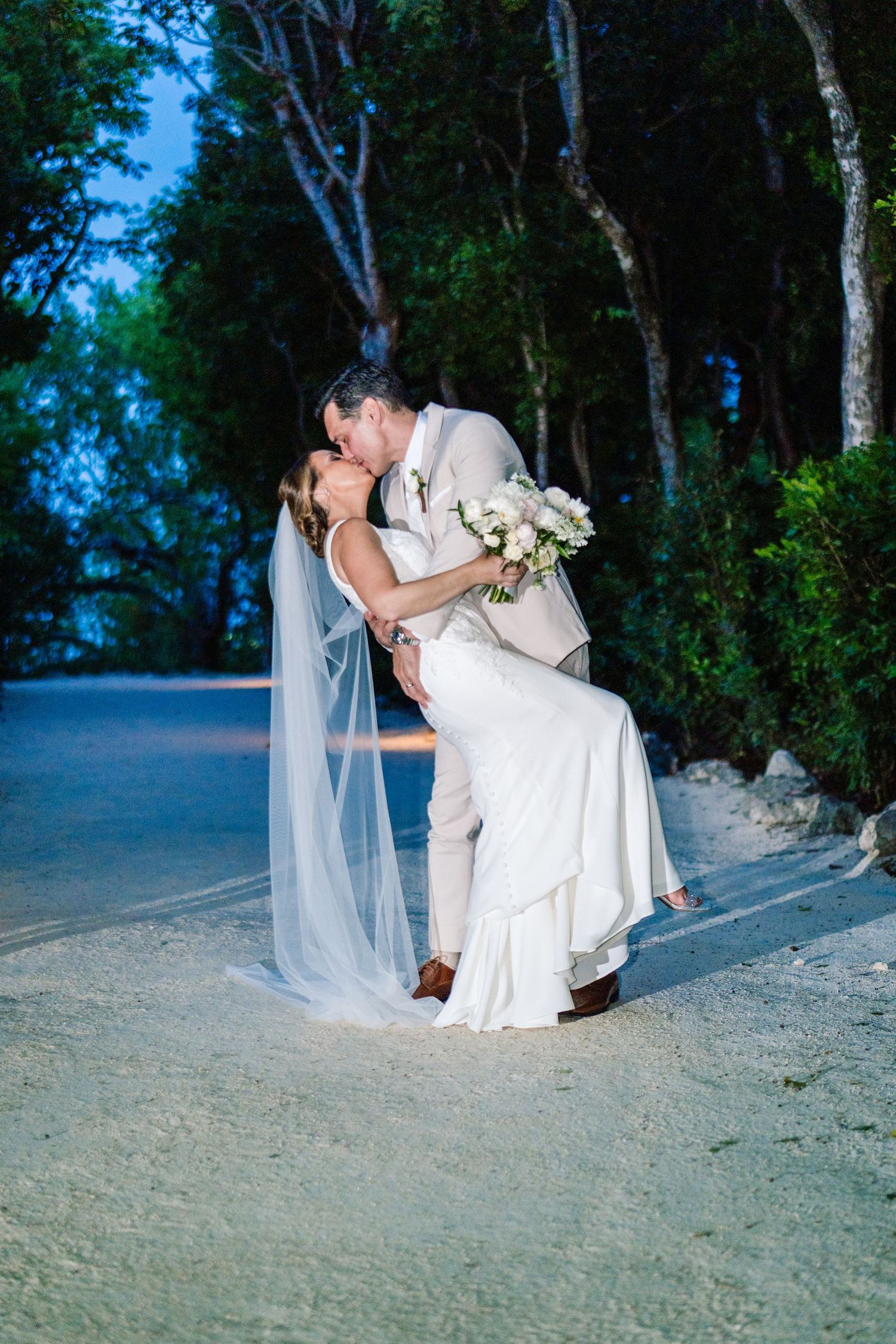 Close-up of bride and groom laughing under the veil, joyful intimate wedding portrait in the Florida Keys