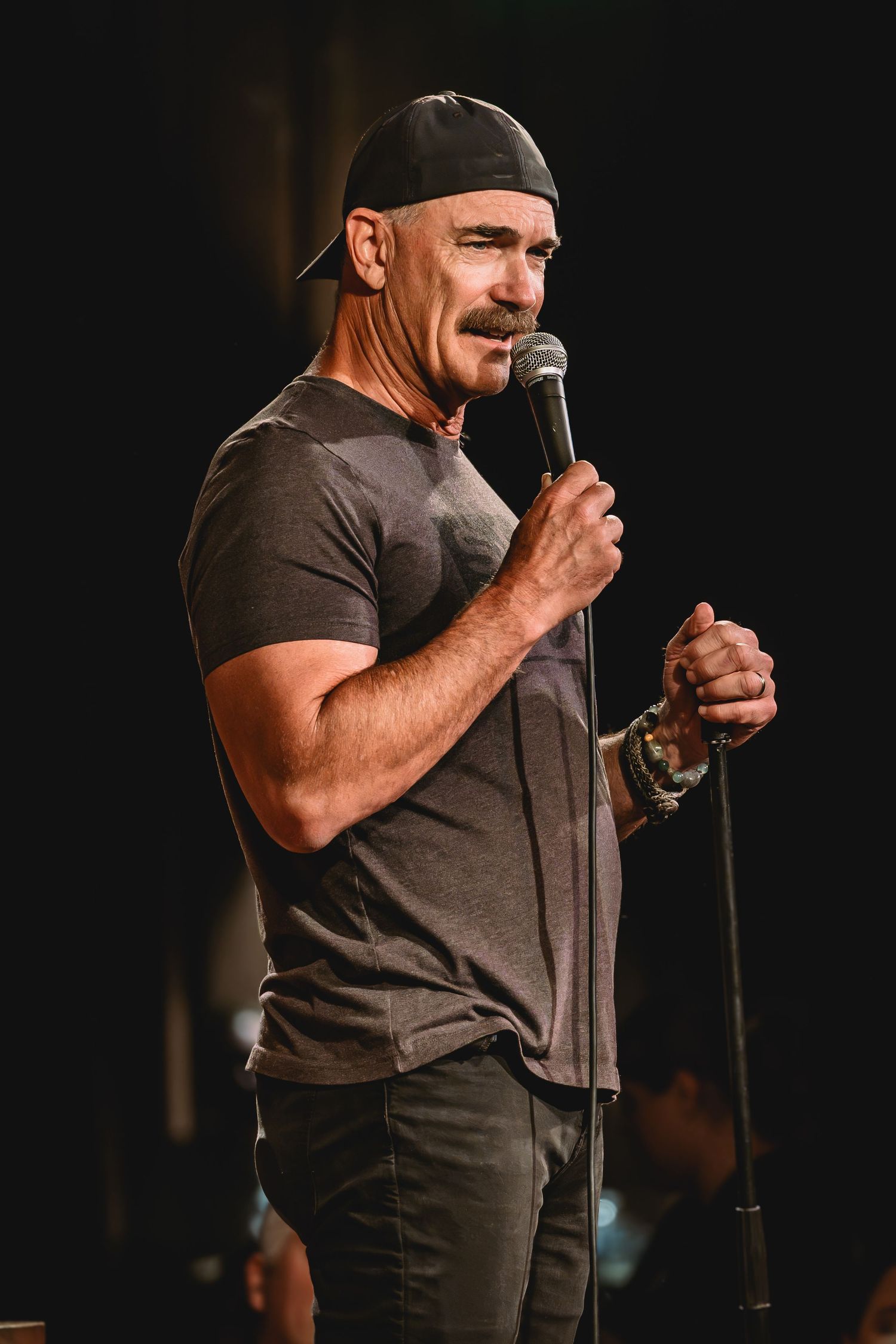Patrick Warburton the comedian performing stand-up comedy on stage holding a microphone at Side Splitters Comedy Club Tampa. Videography.