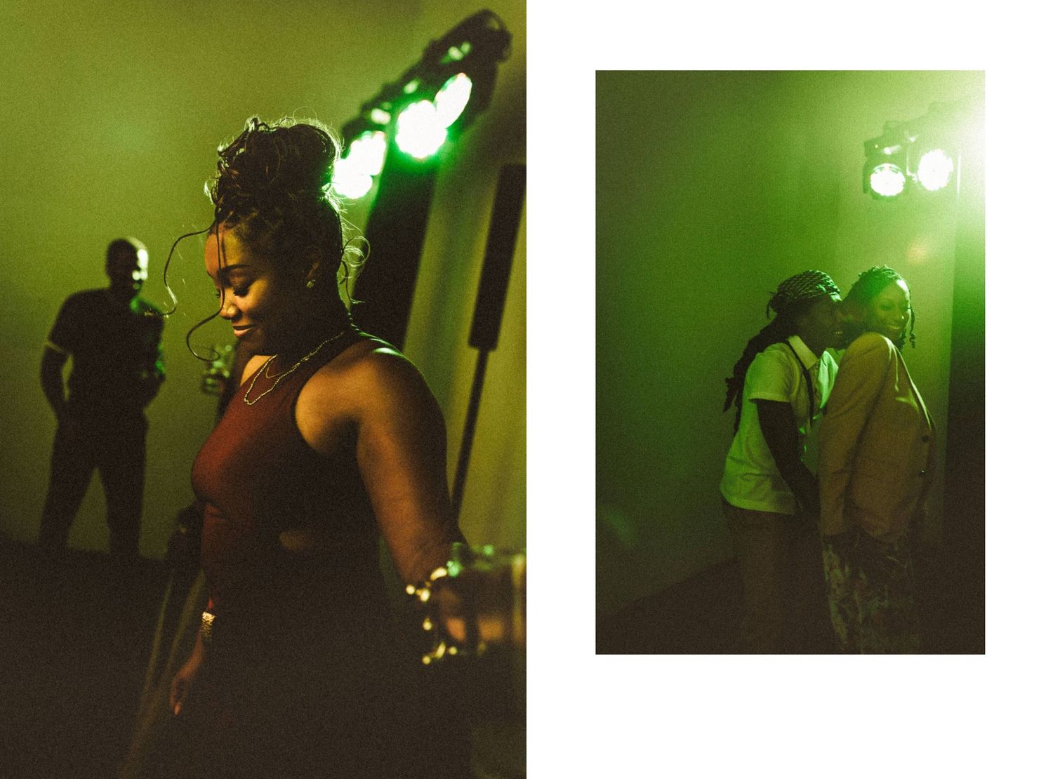 Two Black women pose under green stage lights at a music event, one with braids and fairy lights, another embracing someone.