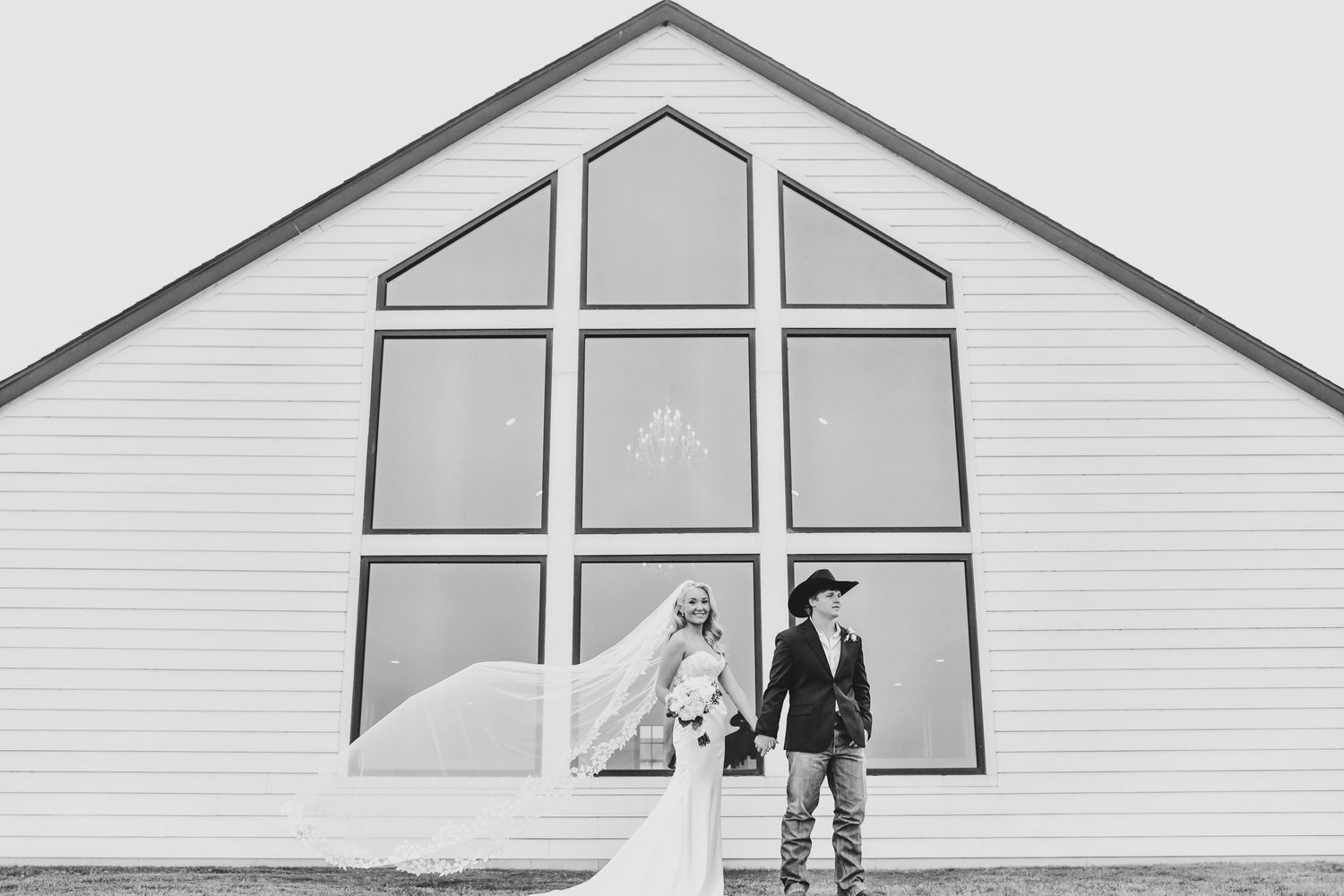 a bride and groom hold hands at the gardenia wedding venue in valley view