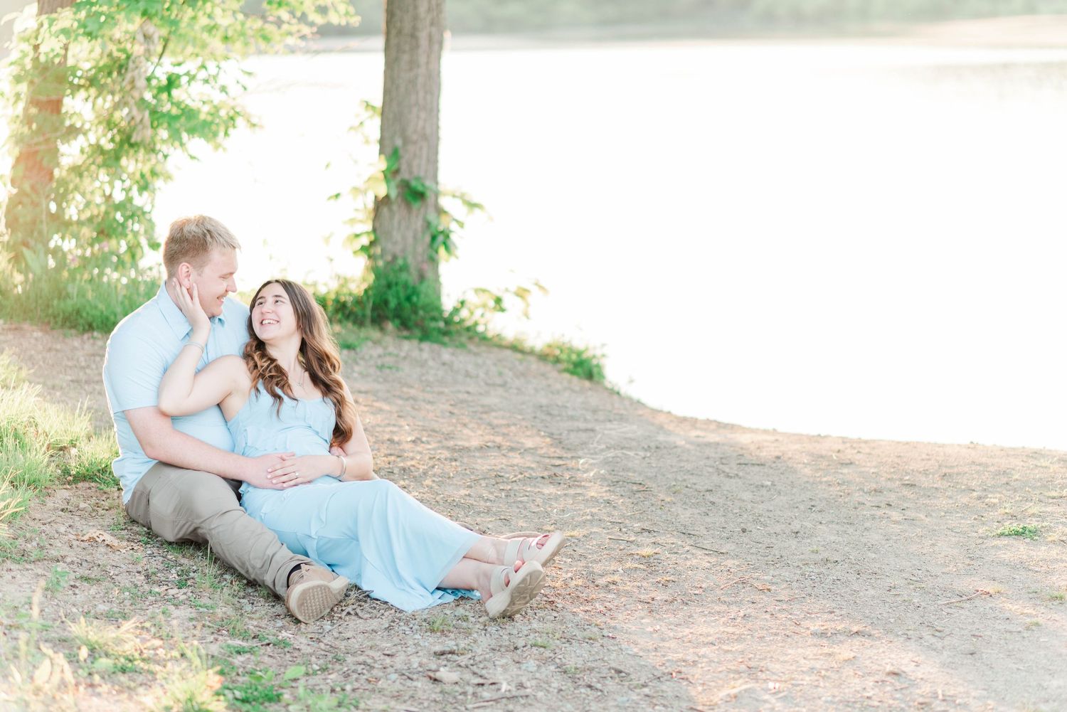 Engagement session at Quemahoning Reservoir in Johnstown Pennsylvania, laying together by the water