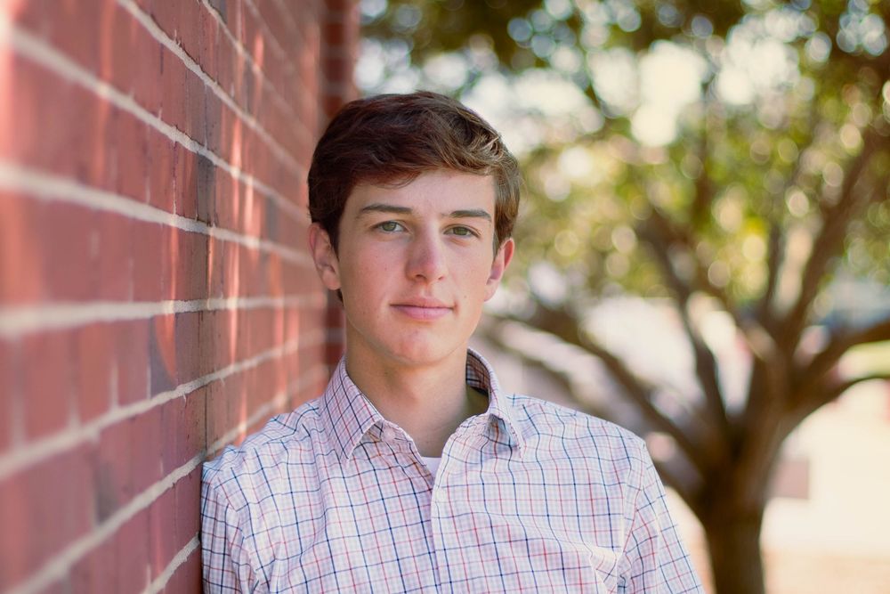 Senior photo in Kansas City at by brick wall.