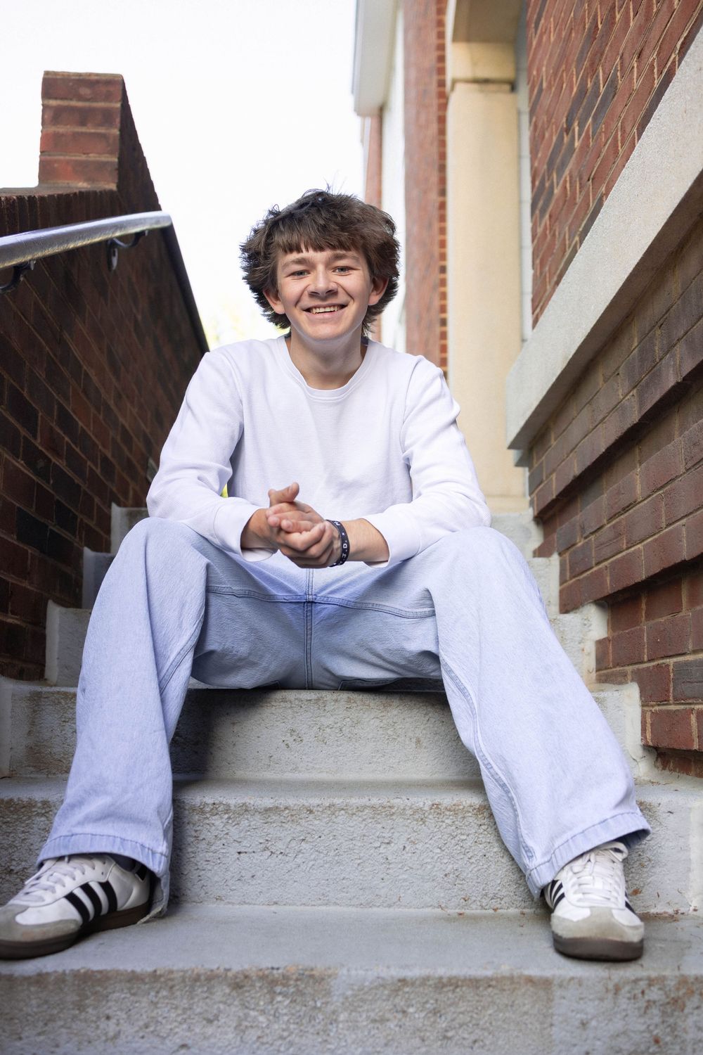 Senior photo in Charlottesville, VA in the city of Charlottesville sitting on stairs.