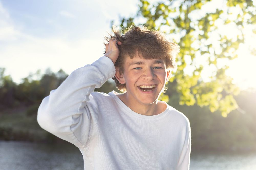 Senior photo in Charlottesville, VA at golden hour with the sunset in the background.
