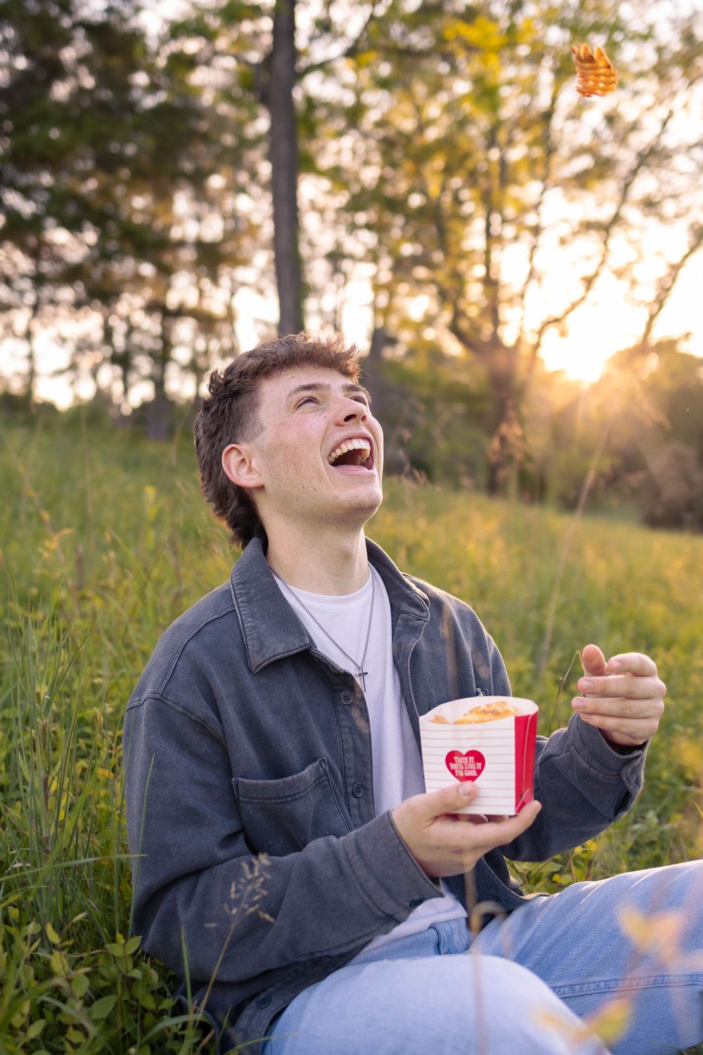 Senior photo in Charlottesville, VA at golden hour with the sunset in the background.  This also incorporates the senior's job.