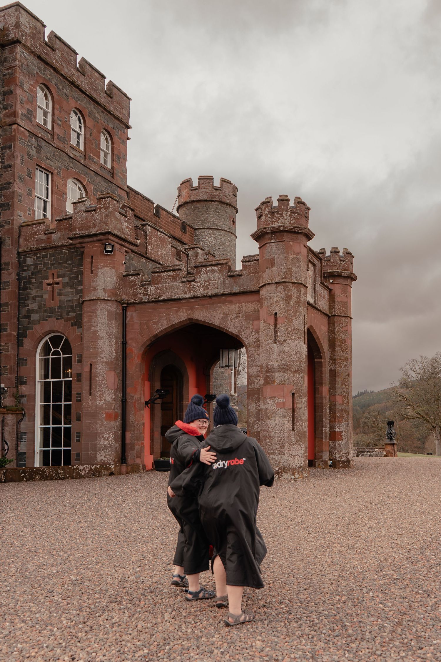 couple embrace as they leave stobo castle photographed by Scottish intimate wedding photographer