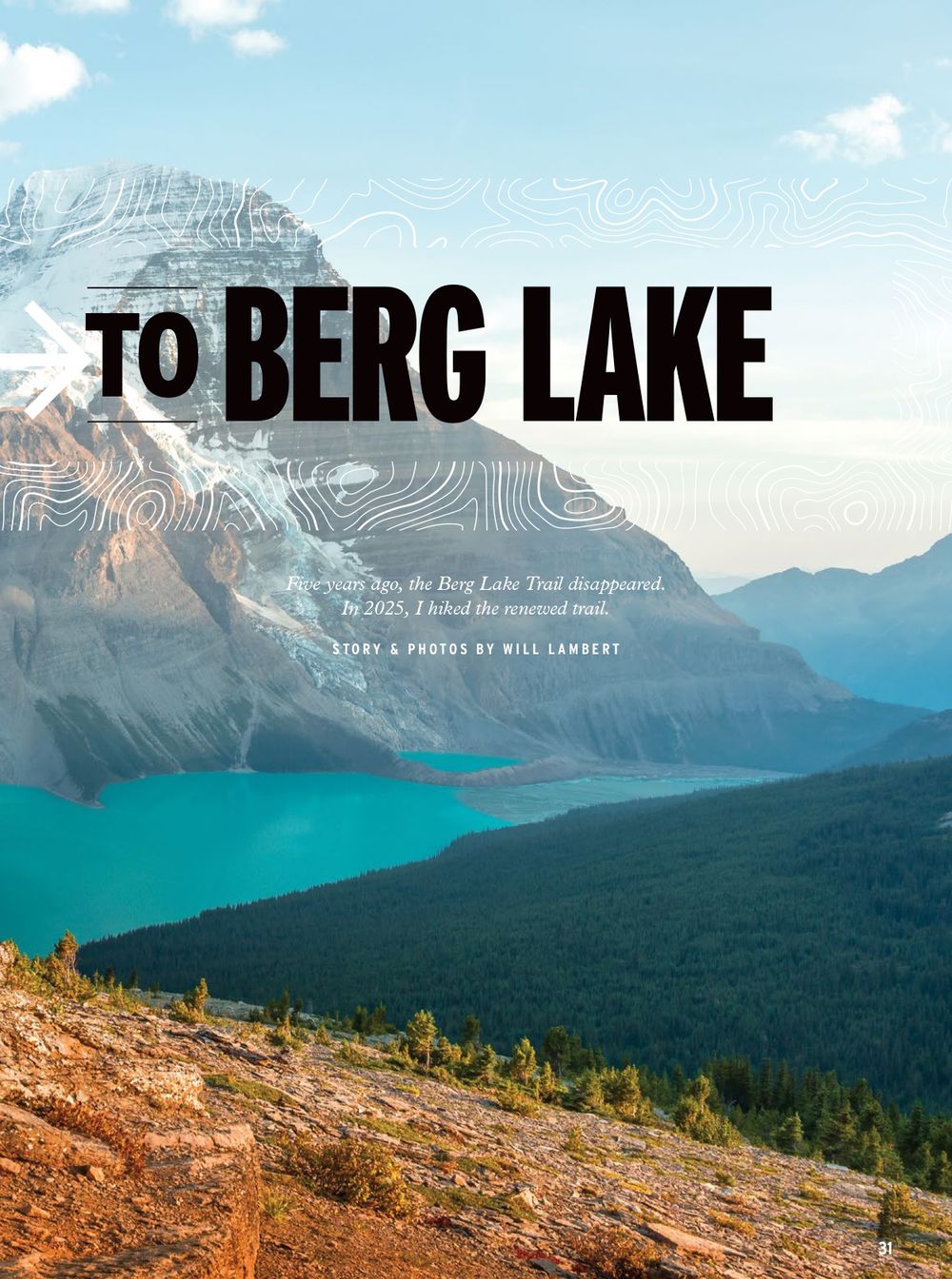 A scenic mountain landscape with turquoise lake waters and evergreen forests stretching beneath snow-capped peaks at dusk.