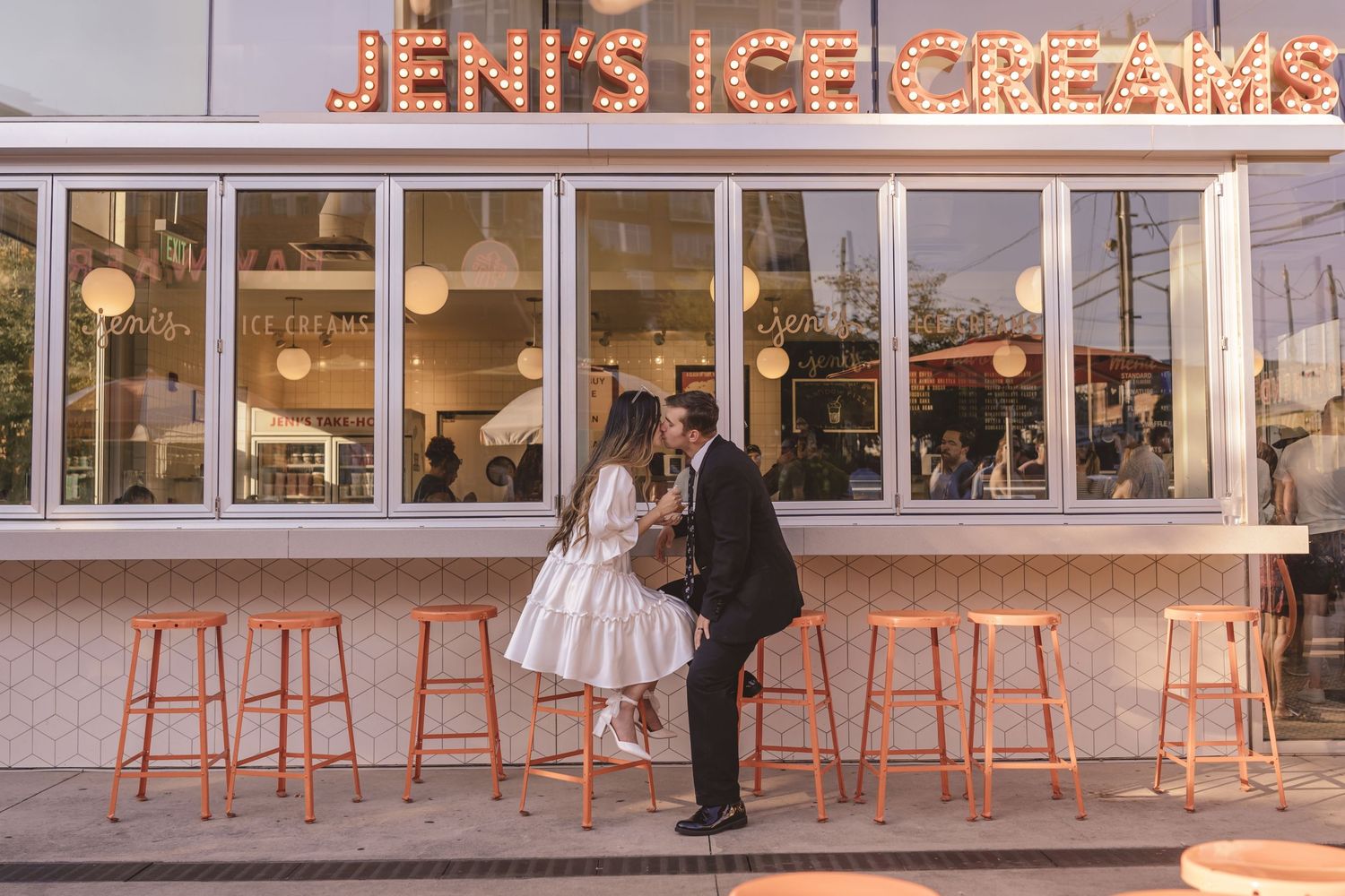 Bride and groom kissing outside of Jeni's Ice Cream shop in Charlotte, NC