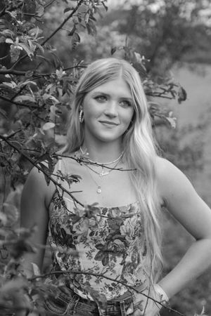 Natural black and white portrait among tree branches showing bohemian summer style. Virginia graduation/senior session.
