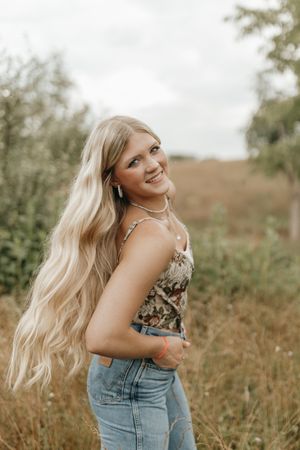 Natural outdoor portrait with long blonde hair and casual denim style. Virginia graduation/senior session.