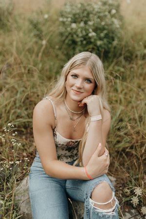 Casual outdoor portrait on rocks with denim and delicate jewelry. Virginia graduation/senior session.