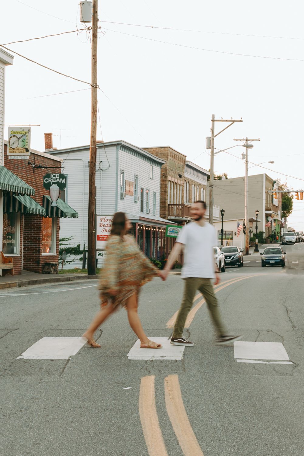 Couple crossing street in vintage-style photo with urban backdrop. Floyd, VA