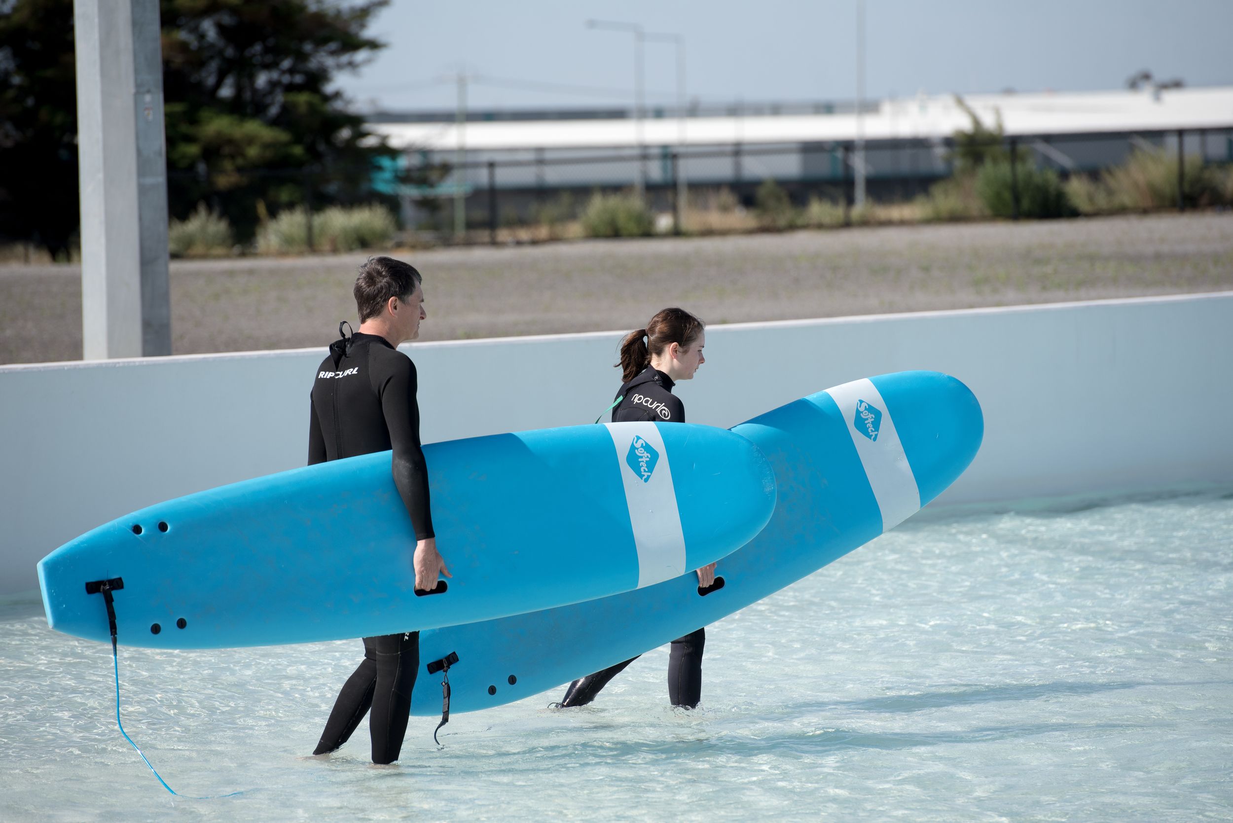 People with surfboards at Urbansurf