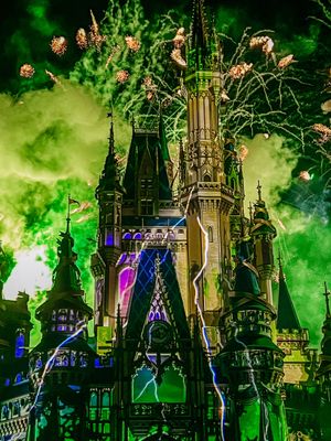 Gothic cathedral silhouettes against a dramatic green sky with illuminated purple lights creating an ethereal atmosphere.