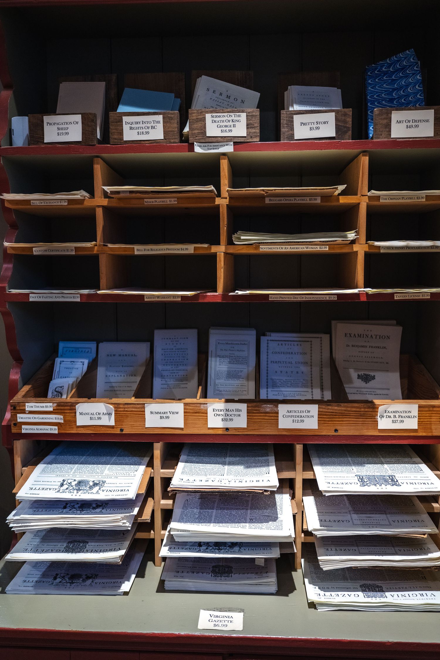 Wooden shelves filled with stacked papers and documents in organized compartments spanning multiple rows and levels.