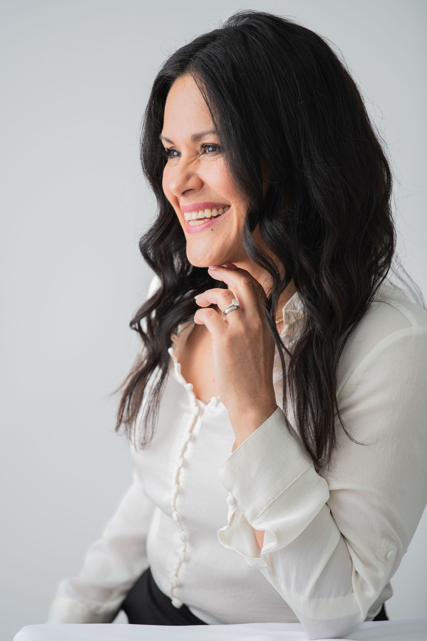 A very happy lady captured in a studio headshot, radiating confidence and joy, perfect for personal branding and professional portraits!