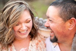 Intimate outdoor portrait of a couple sharing a joyful moment together.