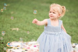 A magical moment with soap bubbles floating in a sunlit garden.