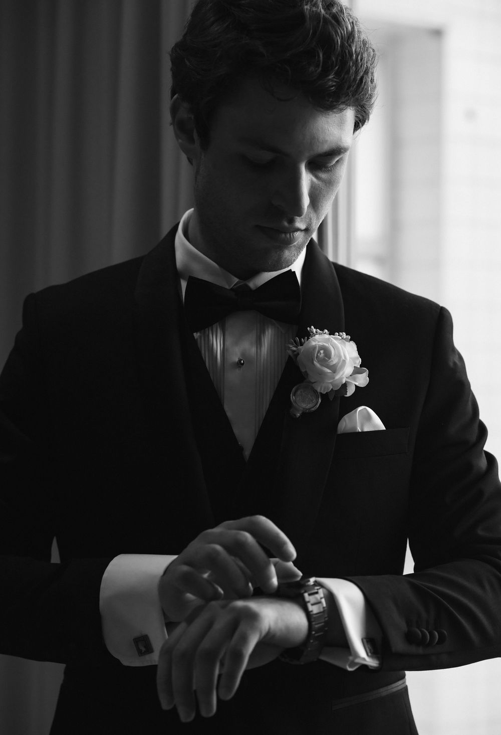 A black and white photo sequence shows a person in a suit adjusting their watch in dramatic lighting.