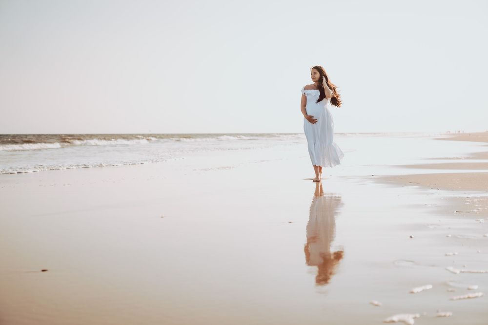 new mom reminiscing about her pregnancy on the beach at Robert Moses during maternity shoot by root sand memories