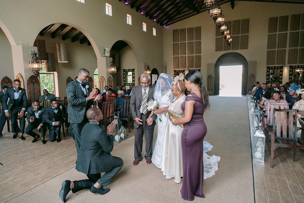 Wedding party gathering around bride and groom at church altar ceremony. Palala Boutique Game Lodge & Spa.