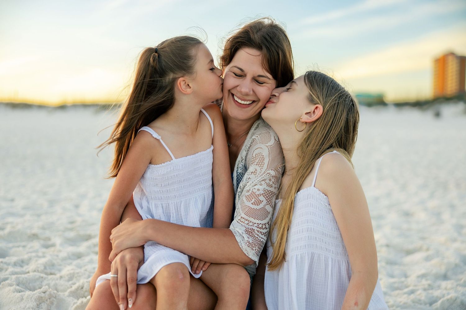 a mother watching her kids play during golden hour on the beach