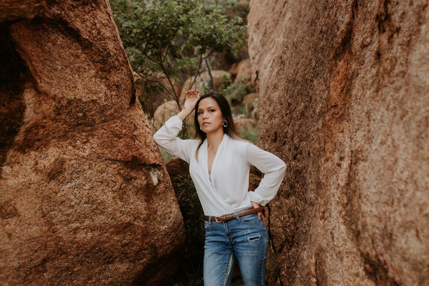 Christina standing amongst the red rocks at the Granite Mines in Mount Isa