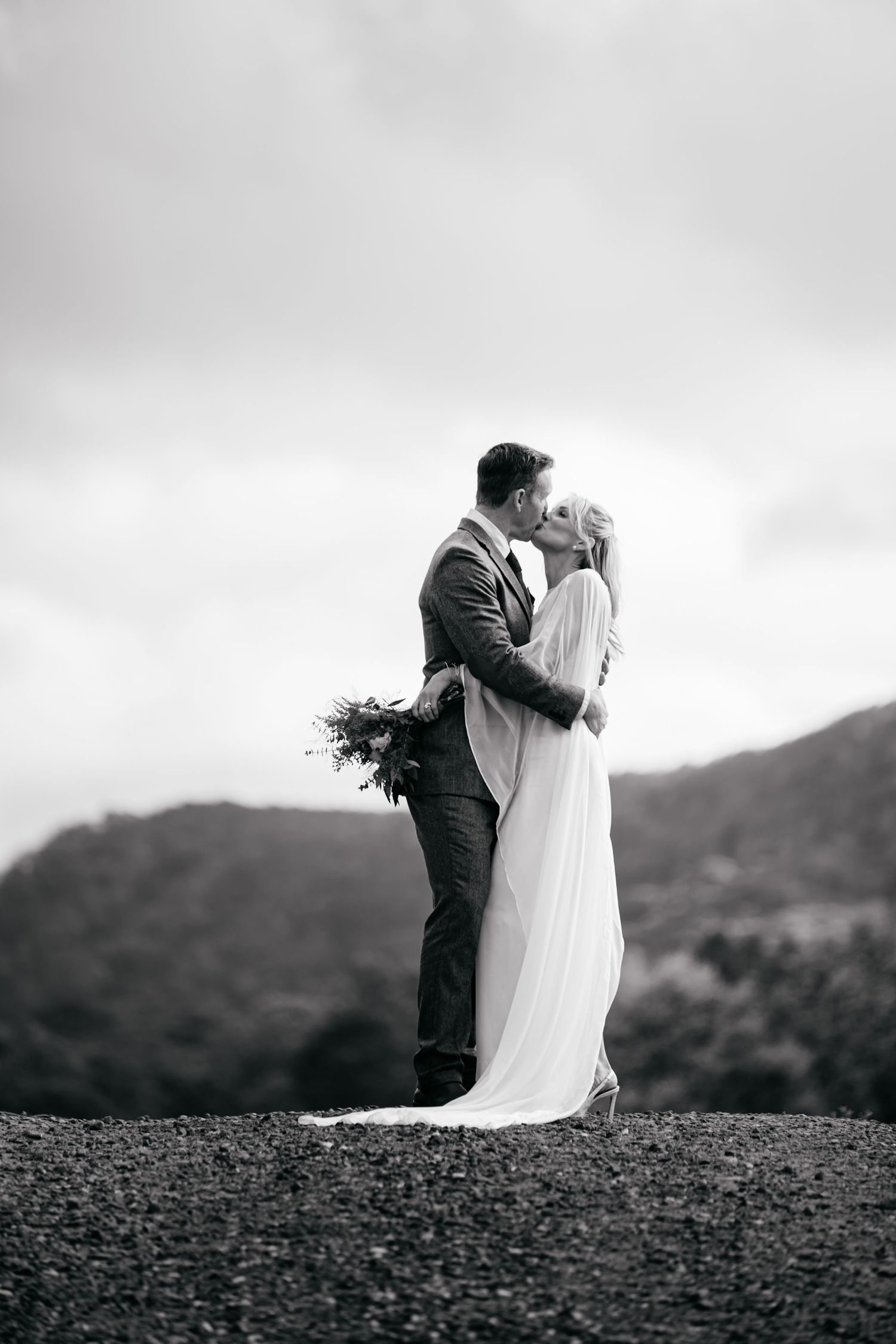 A romantic black and white wedding photo sequence shows a couple embracing against a NC mountain landscape. Matt Johnson Photo