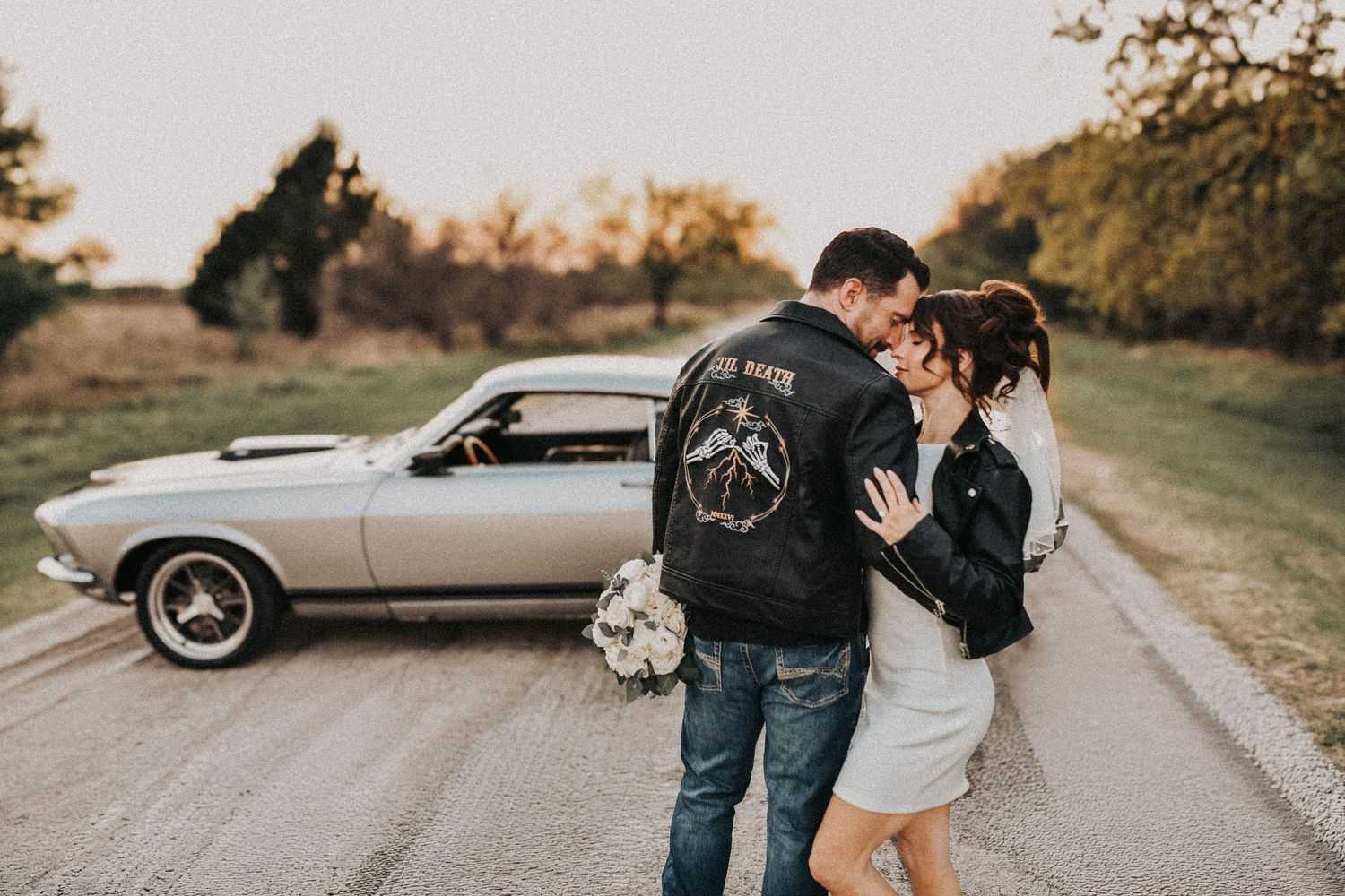 editorial couple leaning against classic muscle car romantic engagement photos