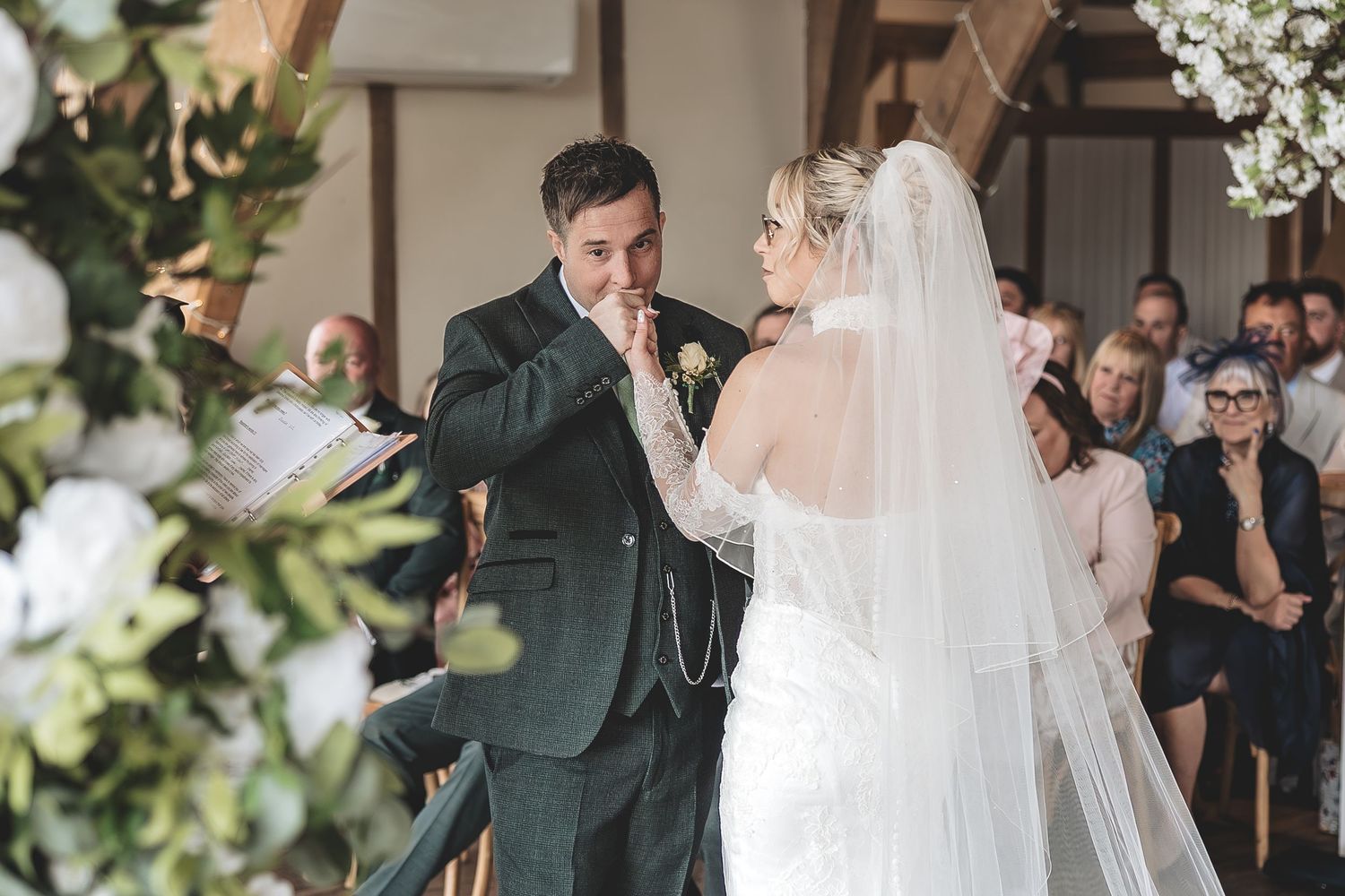 A genuine ceremony moment between bride and groom.