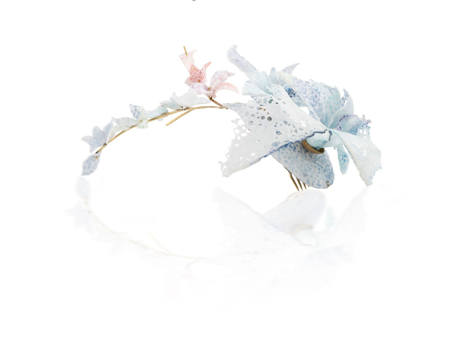 Delicate light blue floral headband with butterfly accents on a white background.