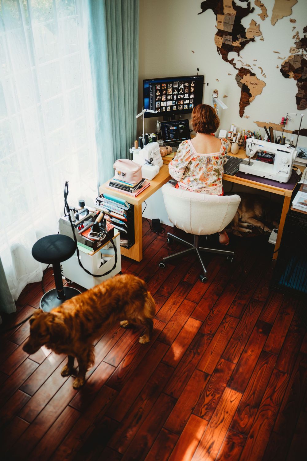 Cozy room interior with hardwood floors, turquoise curtains, and a world map wall decoration.