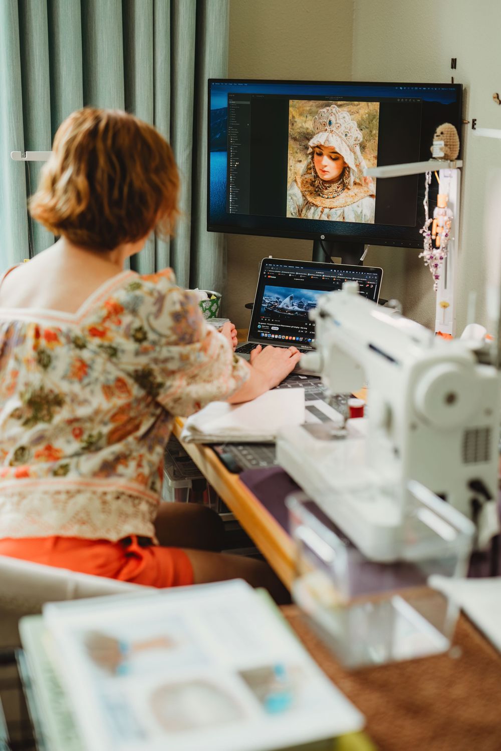 Artist's desk setup with computer monitors and artwork displayed while working on creative projects.