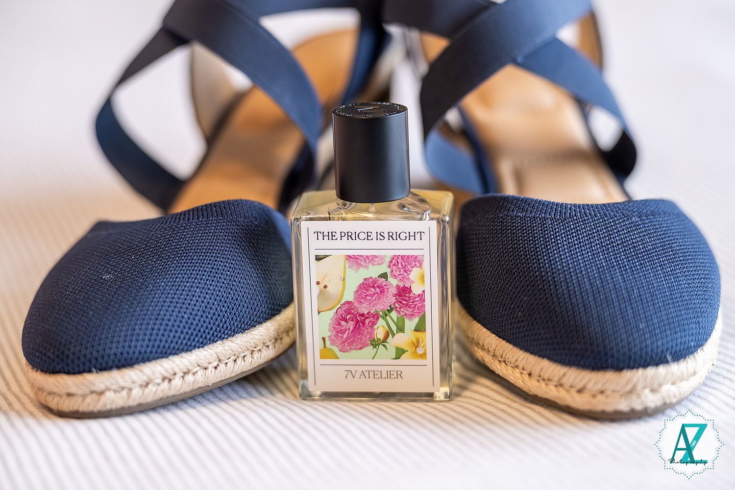 Navy blue espadrille flats with woven jute soles displayed with a decorative vintage-style matchbox.
