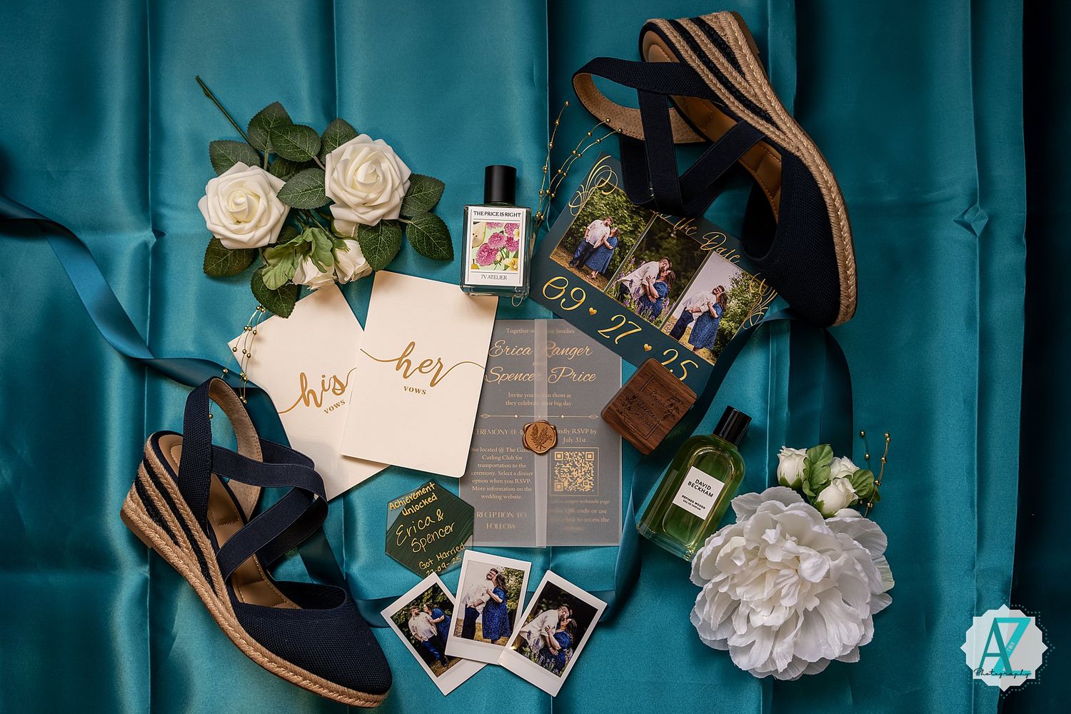 Wedding details including envelopes, flowers, wooden utensils, and photographs arranged on a teal blue background.