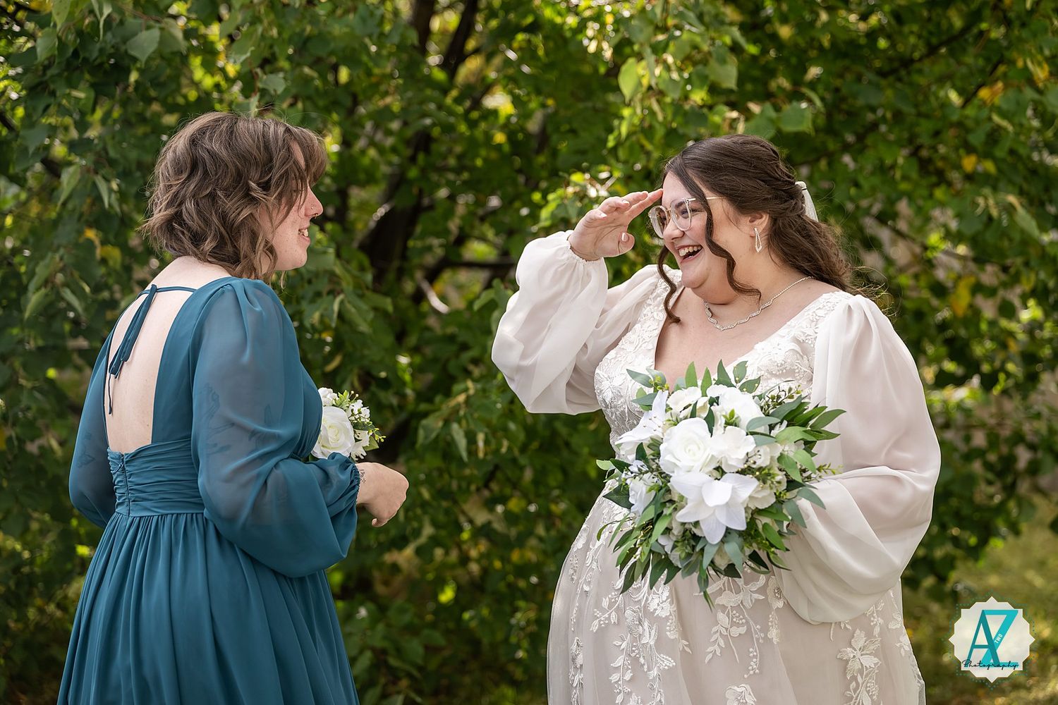 A group of people in blue and white dresses share joyful moments in a garden setting with lush greenery.