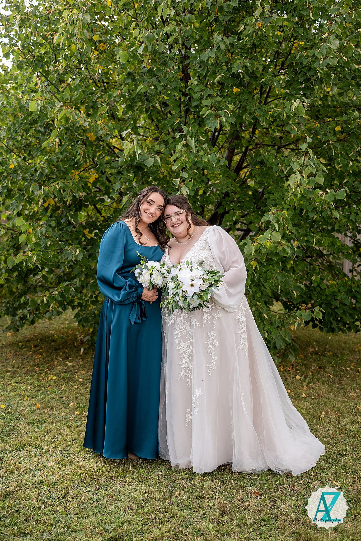 Wedding party members share joyful candid moments together in a garden setting with lush greenery.