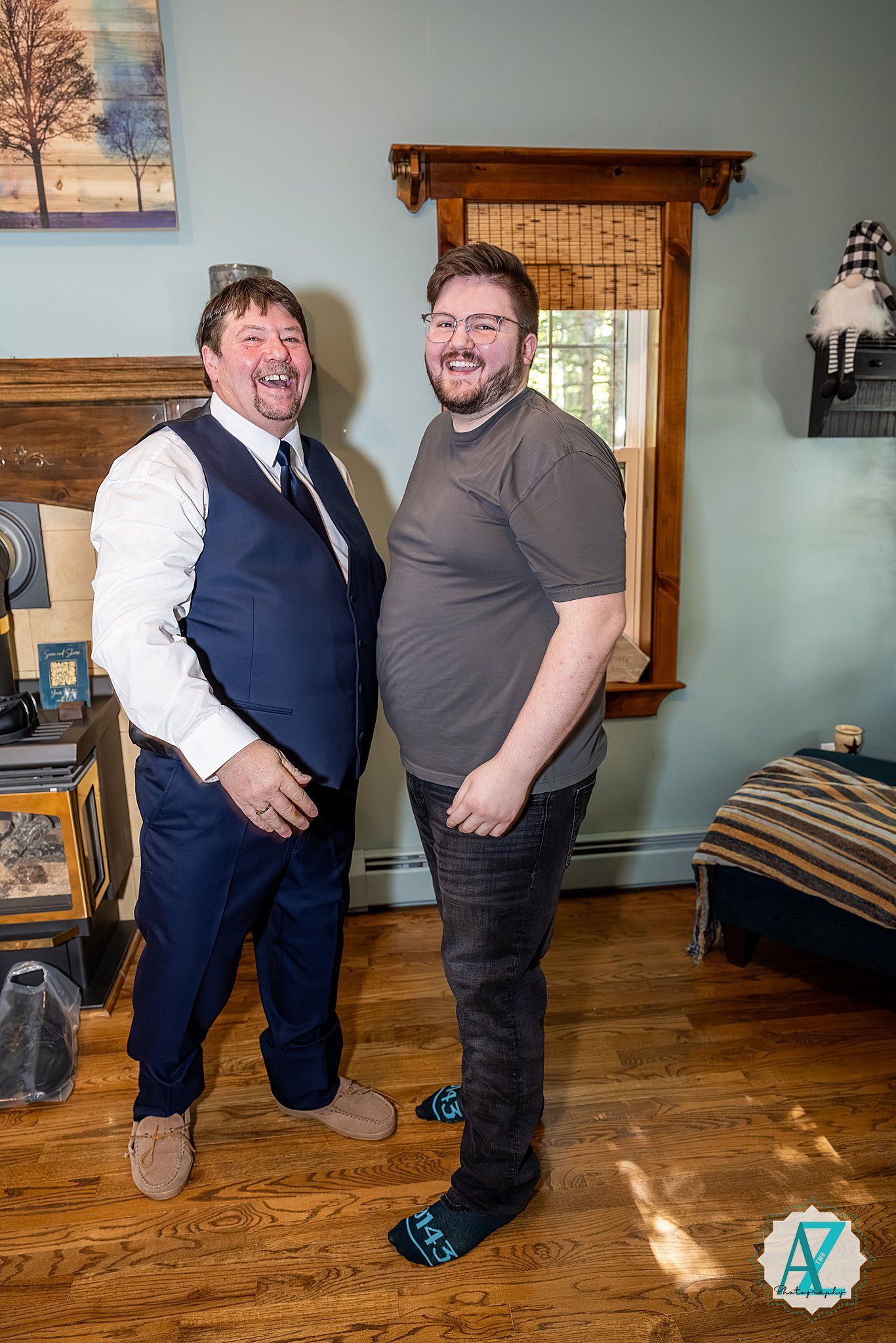 Two people in a rustic room with hardwood floors share a candid moment together.