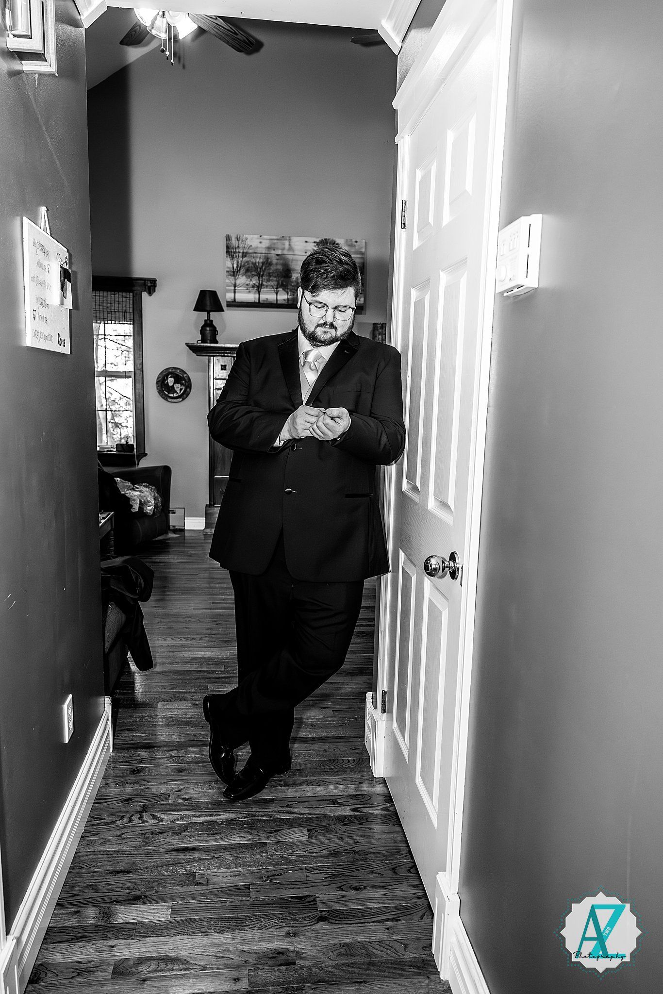 A black and white photo series showing a person sitting in different poses along a hallway with wooden floors.