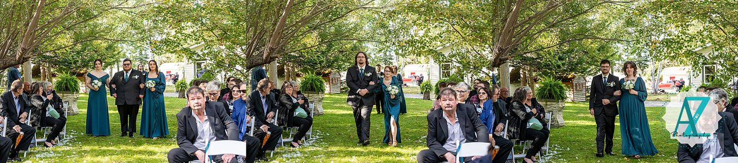 Wedding guests gathered outdoors in a lush garden setting for a celebration.