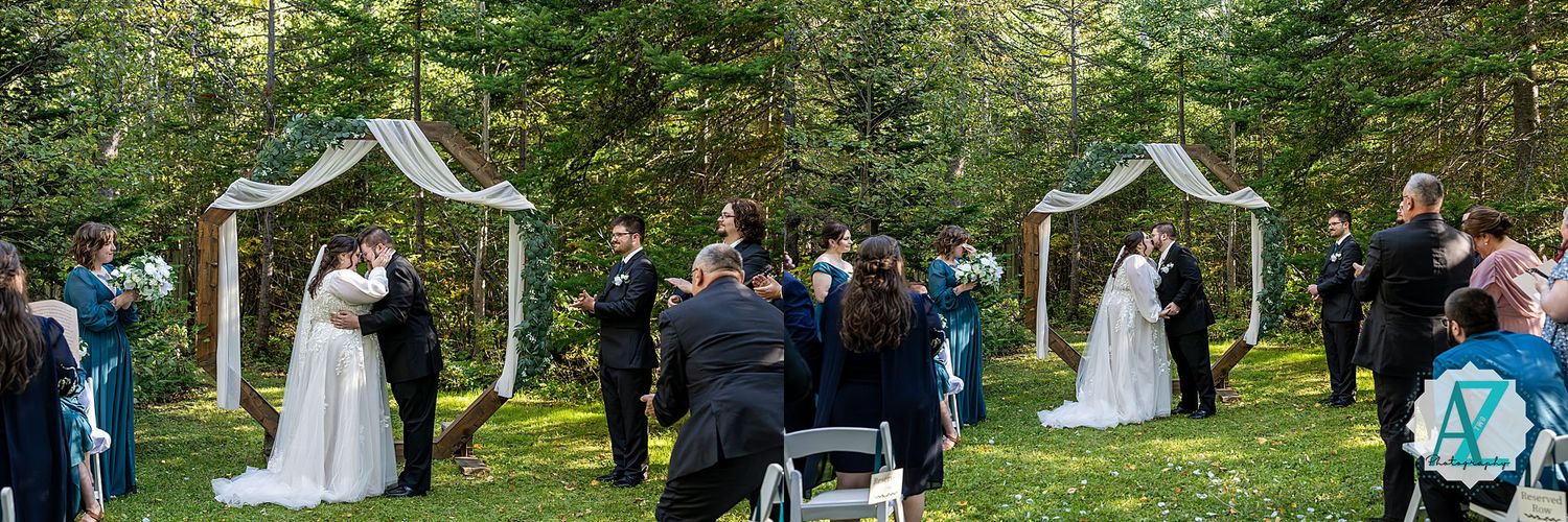 A panoramic view of an outdoor wedding ceremony in a lush green forest setting with white decorative arches.