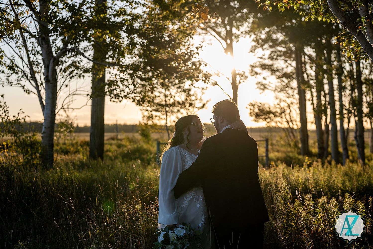 A romantic sunset silhouette photo session in a field with golden light filtering through trees.