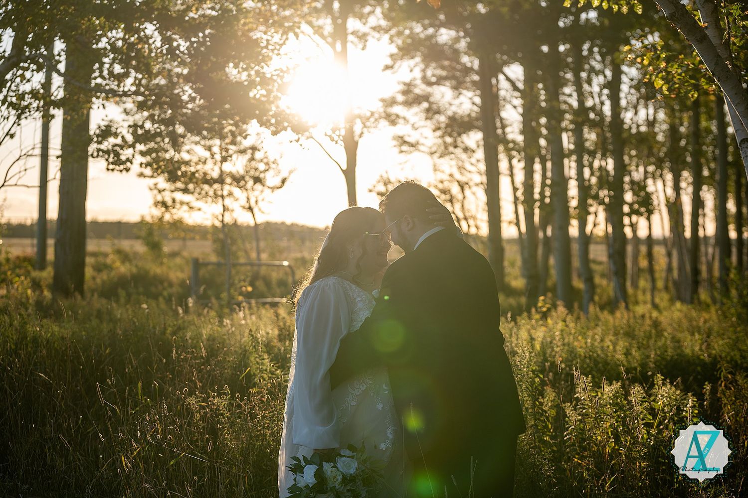 Golden sunset light filters through trees as newlyweds share romantic moments in nature.
