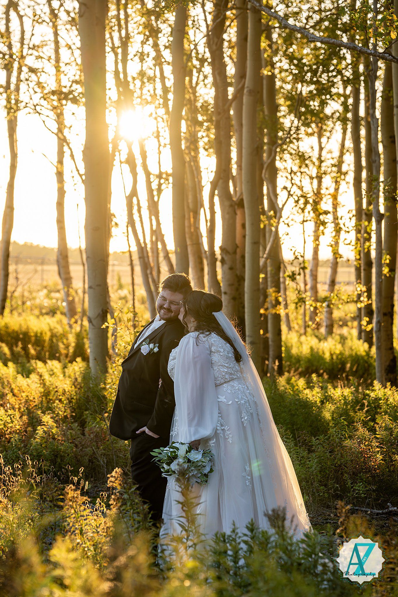 Sunset wedding portraits in a dreamy aspen forest with golden backlight streaming through trees.