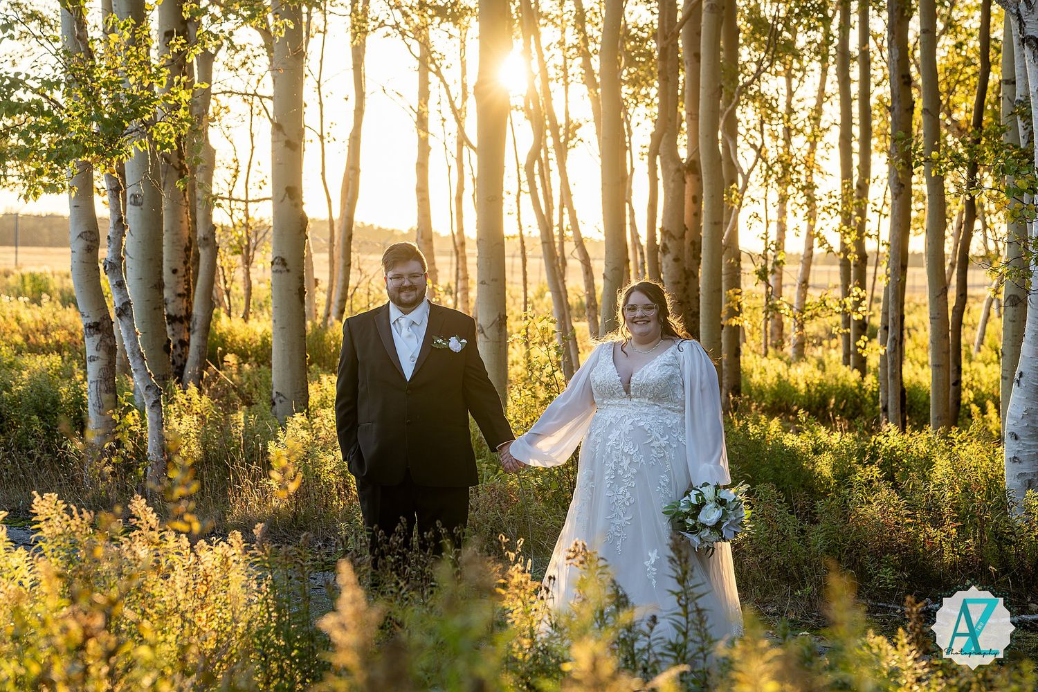 Elegant wedding portraits captured in a dreamy aspen grove during golden hour.