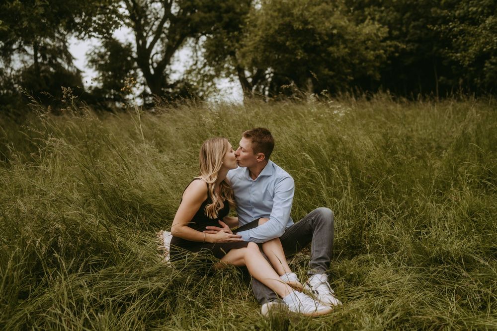 Candid family moments captured in a natural outdoor setting with tall grass.