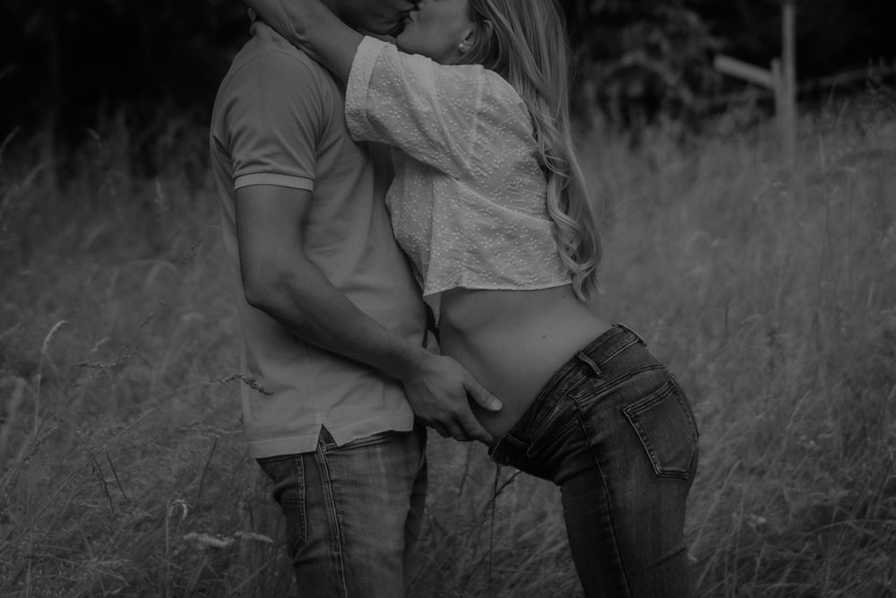 Romantic couple embraces in a grassy meadow during sunset, creating a series of intimate moments.