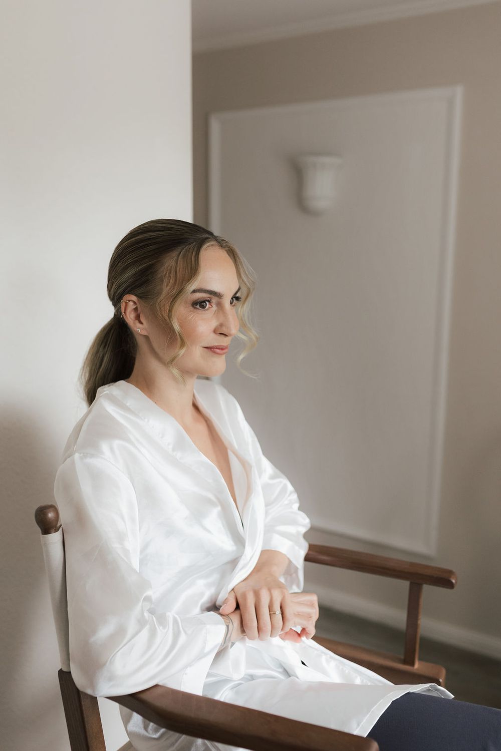 Series of photos showing someone in a white silk robe sitting in a wooden chair in a bright interior setting.