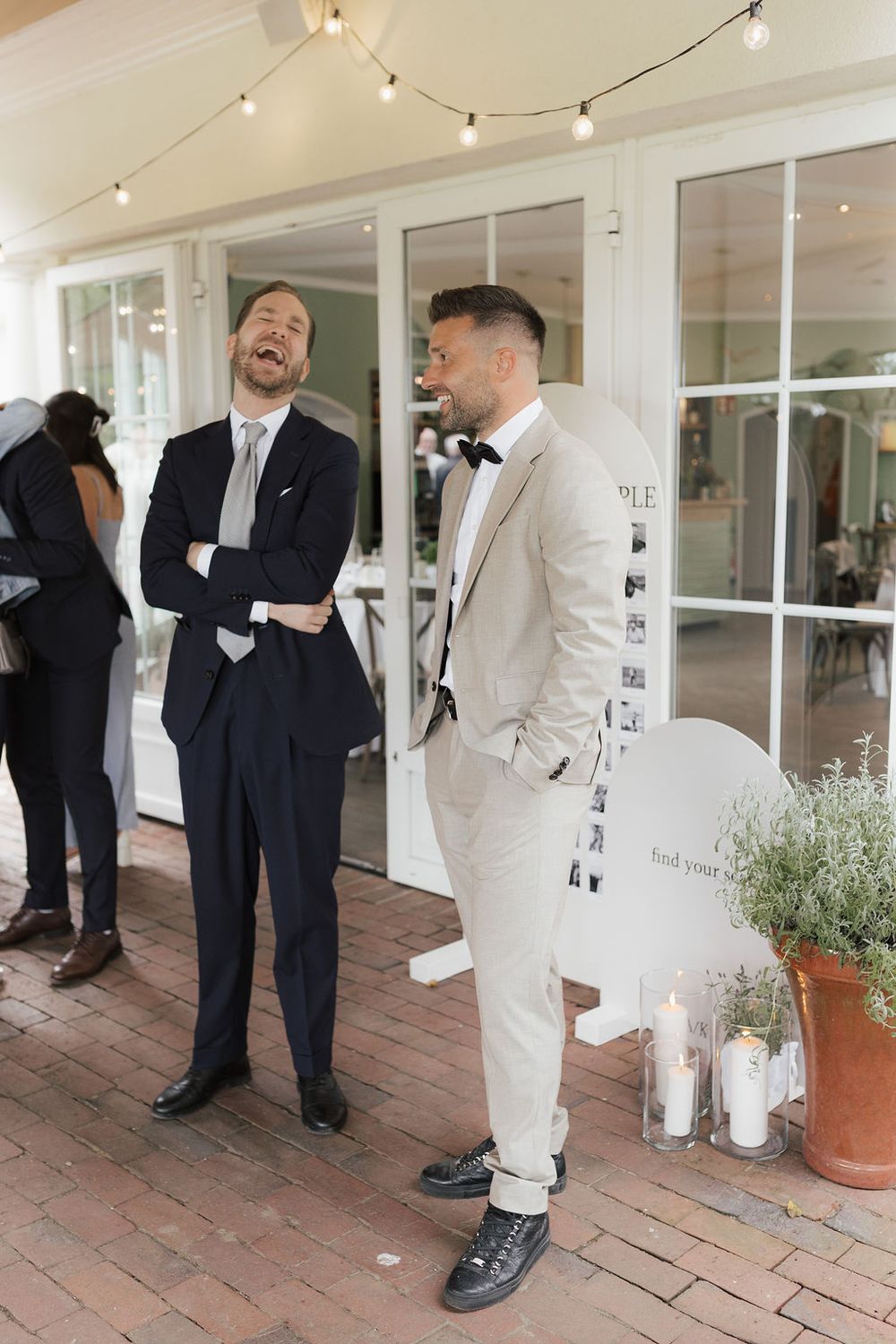 A series of candid moments showing people in formal attire interacting on a brick patio with string lights overhead.
