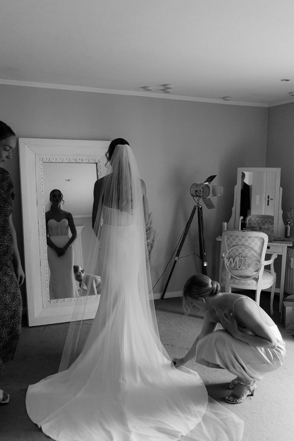 Black and white photos showing the flowing movement of a white wedding veil in an indoor setting.